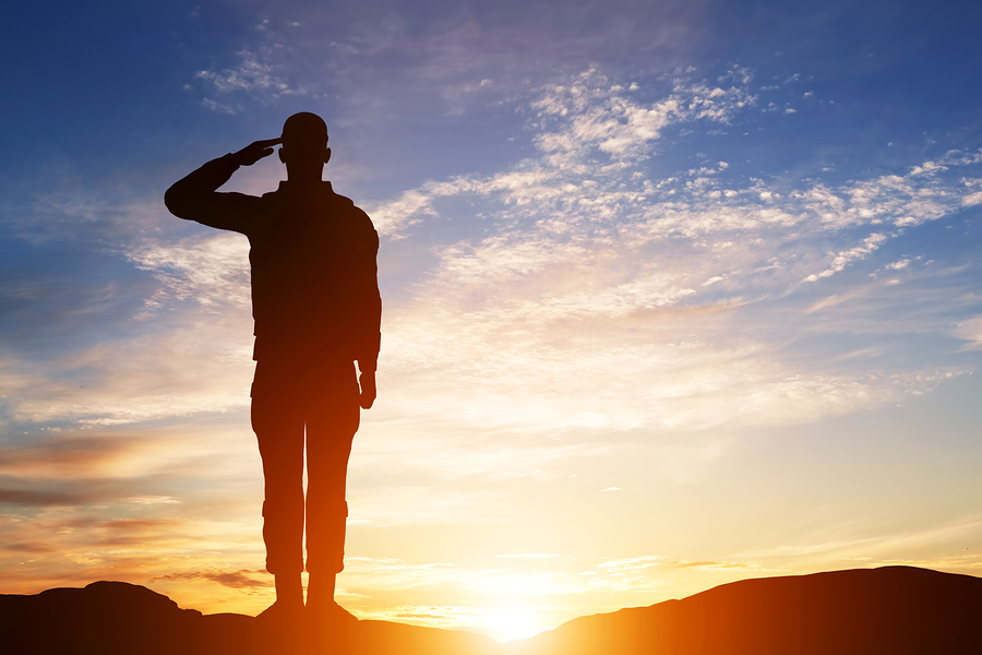 Soldier salute. Silhouette on sunset sky. War, army, military, g